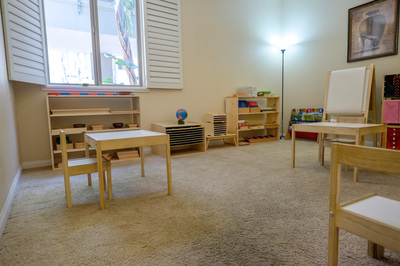 Classroom with Montessori shelves and tables